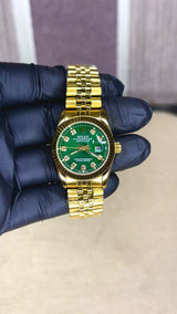 ROLEX GIRL GOLD AND GREEN DARK